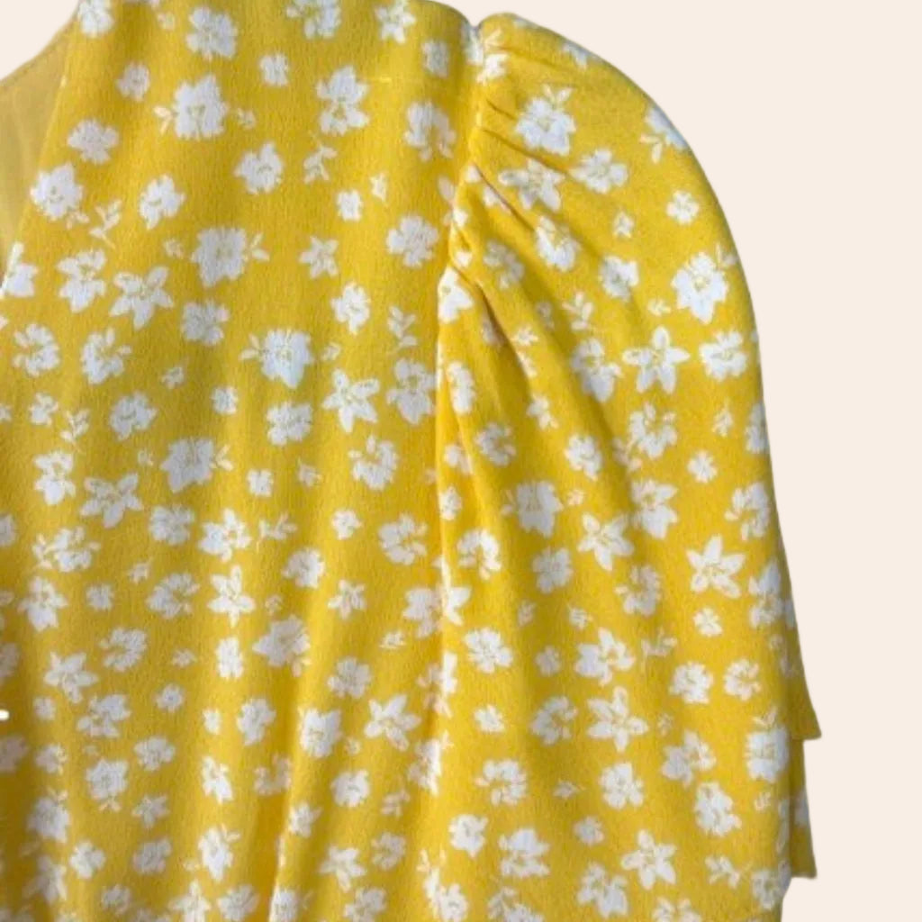 This is a yellow floral printed dress from Sassafras